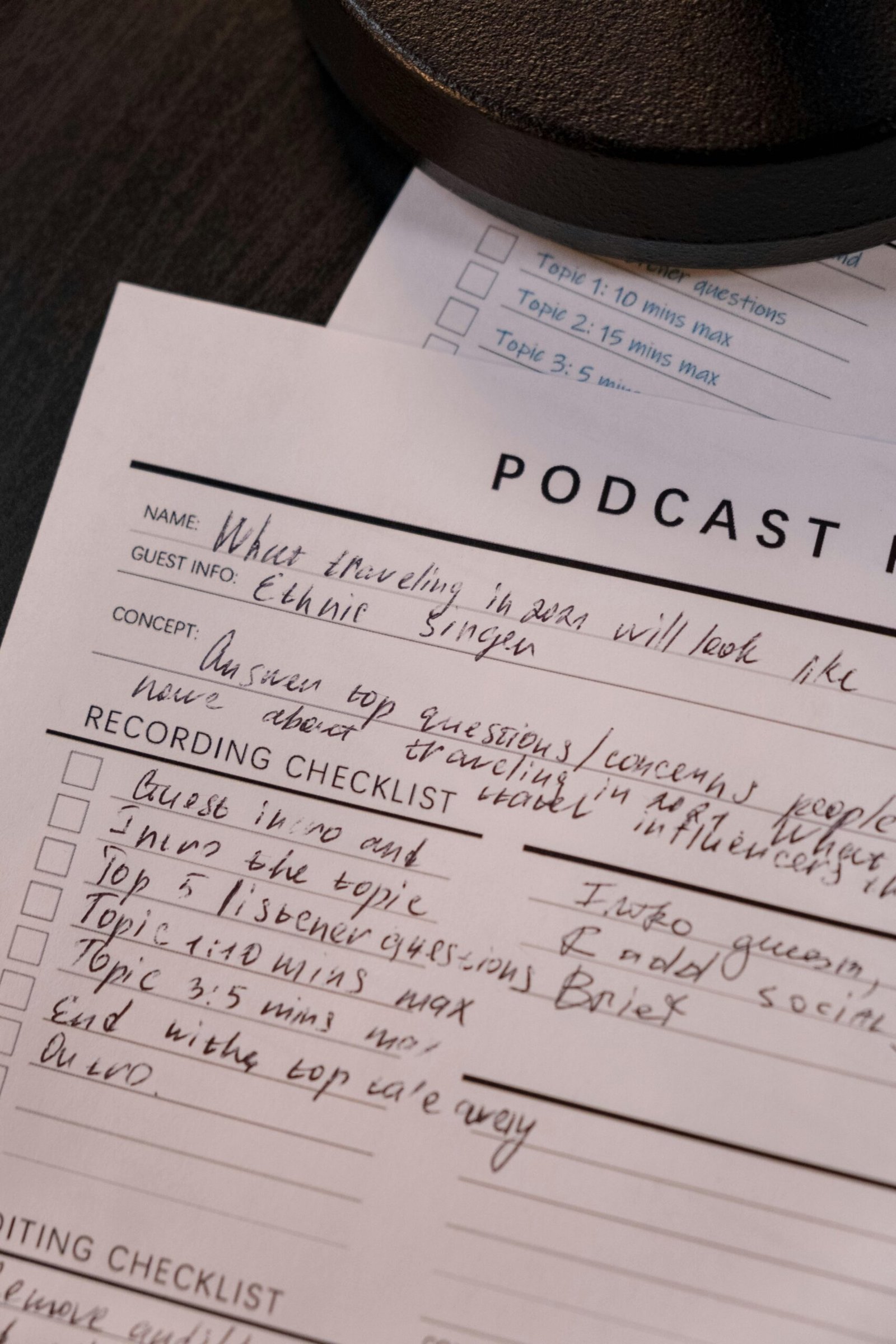 Detailed podcast planning sheet with handwritten notes for effective recording.